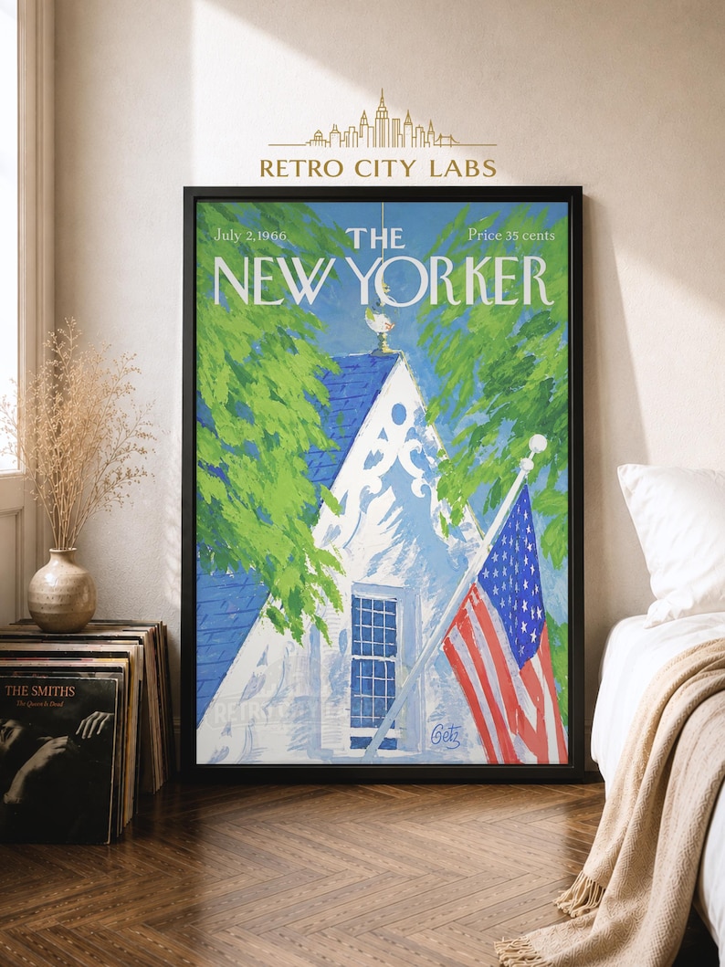 May include: A framed wall art print of The New Yorker magazine cover dated July 2, 1966. The illustration features a white house with a blue roof, green trees, and an American flag. The text reads The New Yorker, July 2, 1966, and Price 35 cents.
