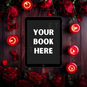 May include: A black tablet computer with a white screen displaying the text "YOUR BOOK HERE" surrounded by red roses and lit candles on a dark wood surface.