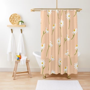 May include: A peach-colored shower curtain with a white daisy pattern. The daisies have yellow centers and green stems.