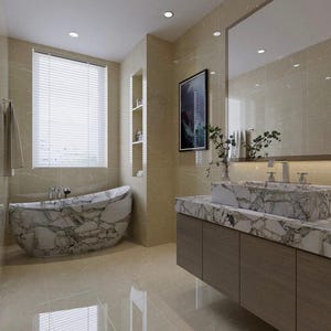 May include: A bathroom interior featuring a freestanding bathtub and a rectangular sink basin, both crafted from white marble with prominent grey veining. The vanity has a wooden cabinet base, and the walls are covered in large beige tiles.