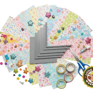 May include: A craft kit with patterned paper, gray corner protectors, decorative tape, scissors, buttons, and glittery star and heart embellishments. The kit includes a variety of floral and polka dot designs.