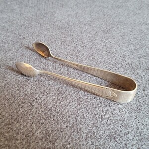 Antique silver-plated sugar tongs.