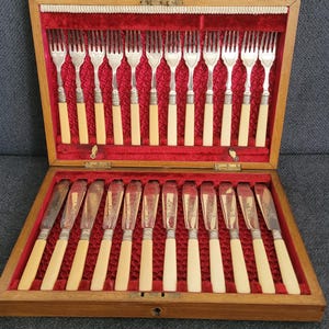Antique silver-plated fish knives and forks.