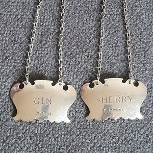 Two vintage silver labels for a decanter with a chain