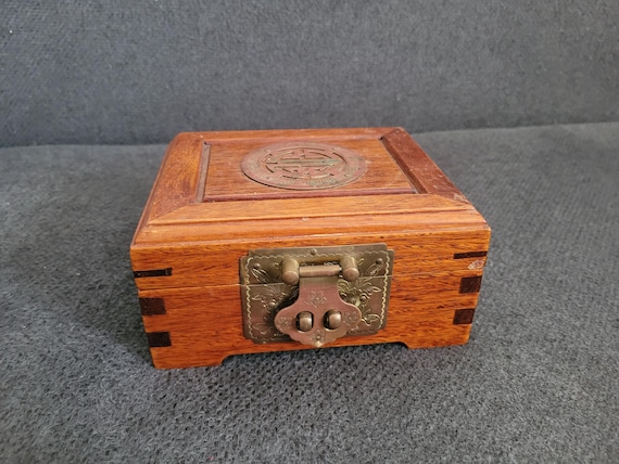 Elegant vintage wooden jewelry box with traditional Asian design elements