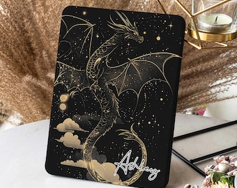 May include: Black and gold tablet case featuring a dragon design with the name "Ashley" written in cursive.