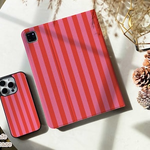 May include: A smartphone case and a tablet cover featuring a vertical striped pattern in alternating shades of bright red and light pink. Both items have a smooth finish and are designed to protect mobile devices with precise cutouts for cameras.