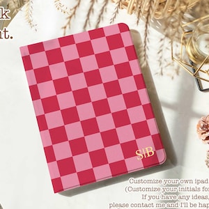 May include: Pink and red chequered iPad case with gold initials "SIB". The case is shown on a white surface with text that says "Book front."