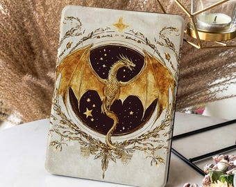 May include: A gold dragon with outstretched wings is depicted against a dark blue background with gold stars. The dragon is surrounded by a gold wreath with a star at the top. The design is on a white background with a textured surface.