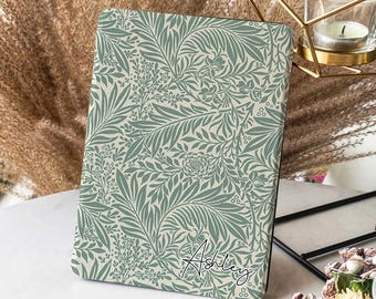 May include: A green and cream floral patterned case for an e-reader with the name "Ashley" written in black cursive on the bottom right corner.