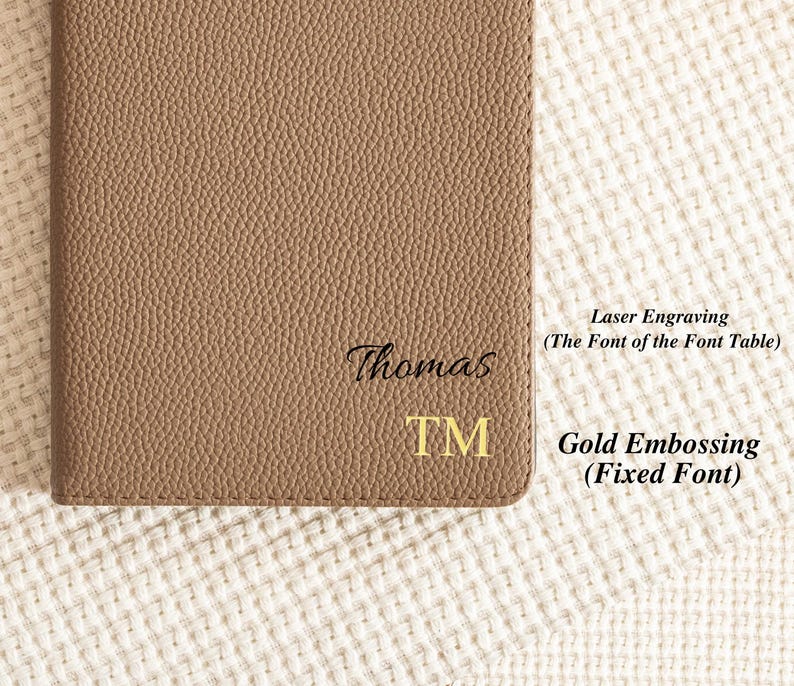 May include: A brown leather notebook with the name "Thomas" and the letters "TM" engraved in gold. The text "Laser Engraving (The Font of the Font Table)" and "Gold Embossing (Fixed Font)" are written in black text on a white background.