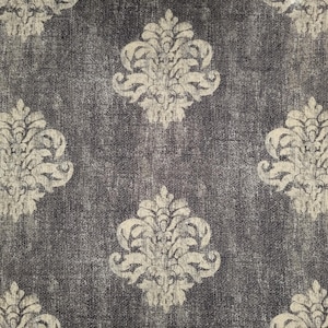 May include: A close-up of a dark gray fabric with a repeating pattern of white damask designs. The fabric has a textured, slightly distressed look.