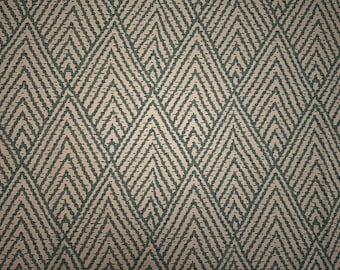May include: A close-up of a fabric with a geometric pattern of teal and beige diamonds.