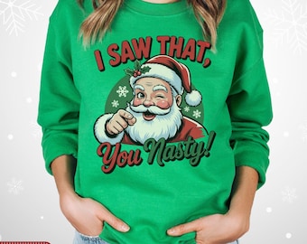 May include: Green sweatshirt with a Santa Claus graphic winking and pointing. The text reads "I SAW THAT, You Nasty!" in red and green. The sweatshirt is Irish green.