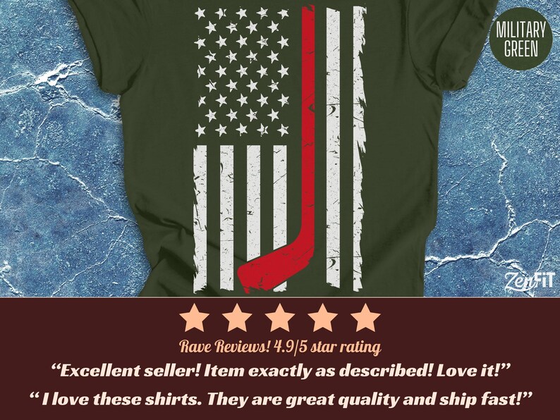 May include: A military green t-shirt featuring a distressed white and red graphic of the American flag. The flag design incorporates a red hockey stick silhouette integrated into the stripes. The shirt has a crew neckline and short sleeves.