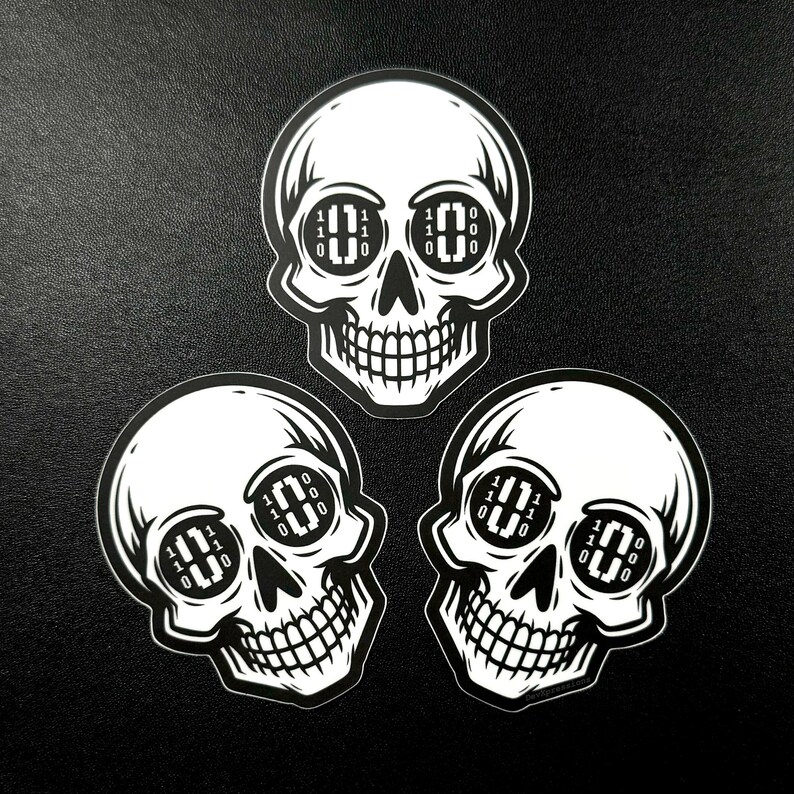 May include: Three black and white skull stickers with binary code in the eye sockets. The code reads "110 010 110 0 0 000".