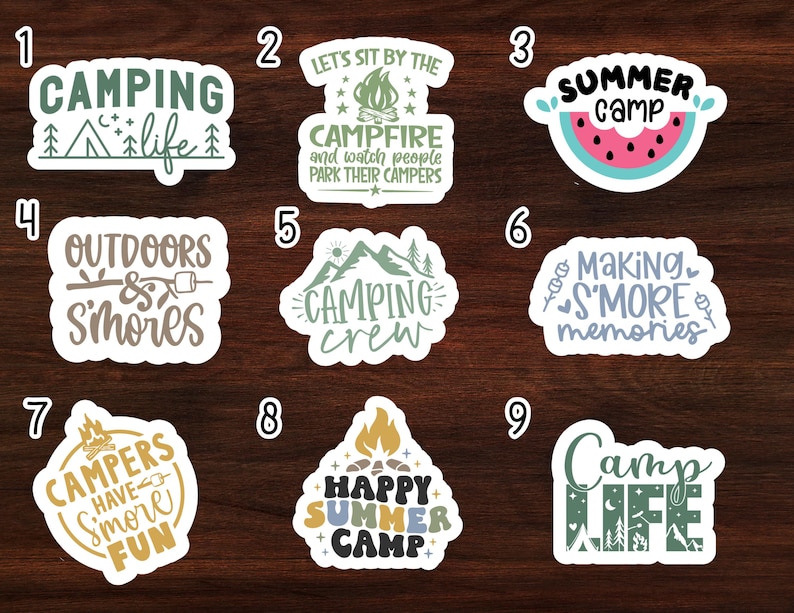 May include: Nine colorful stickers with camping-themed text and illustrations. The stickers feature phrases like "Camping Life", "Campfire", "Outdoors & Smores", "Camping Crew", "Making S'more Memories", "Campers Have S'more Fun", "Happy Summer Camp", and "Camp Life".