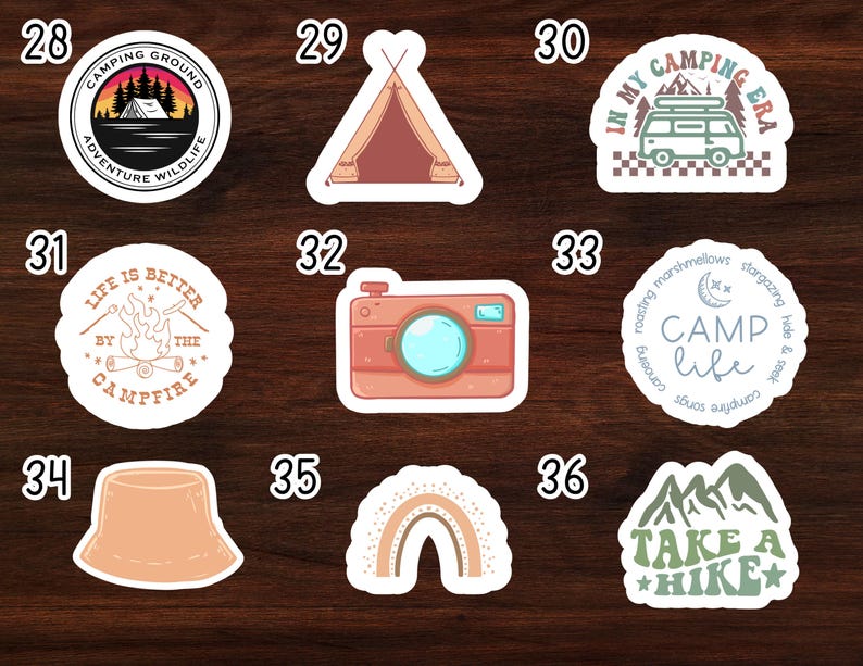 May include: Nine camping themed stickers with various designs. The stickers are white with rounded edges and feature illustrations of a campfire, a tent, a camera, a rainbow, a mountain range, a camper van, and a hat. The stickers also include text such as "Camping Ground", "Life is Better by the Campfire", "Camp Life", and "Take a Hike".