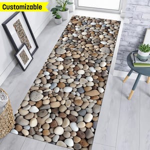 May include: A long, rectangular rug with a realistic stone pebble design. The rug is made of soft, durable material and is perfect for adding a touch of nature to any room.