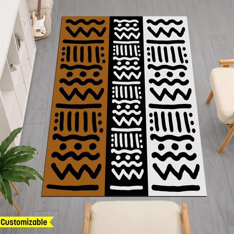 May include: A brown, black, and white patterned rug with geometric shapes. The rug has a tribal design.