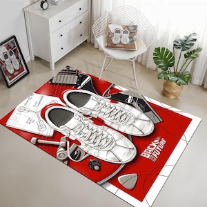 May include: Red and white rug with a black and white illustration of a guitar, two trainers, and the text "Back to the Future".
