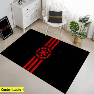 May include: A black and red area rug with a distressed look features the Star Wars Imperial symbol and three red stripes. The rug is customizable.