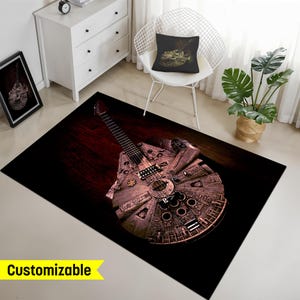 May include: A black and brown area rug with a graphic of a guitar shaped like the Millennium Falcon from Star Wars.