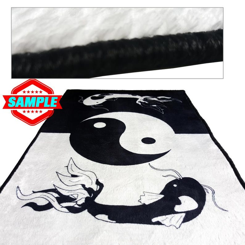 May include: Black and white plush throw blanket with a yin yang symbol and two fish designs. The blanket has a black border.