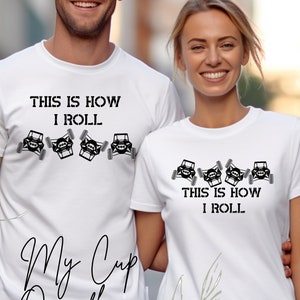 May include: Two white t-shirts with a black graphic of a jeep and the text "This is how I roll".