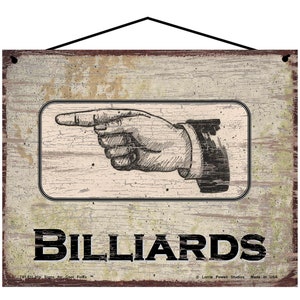 May include: A distressed wood sign with a pointing hand graphic and the text "BILLIARDS". The sign has a rustic, vintage look and is perfect for a game room or bar.