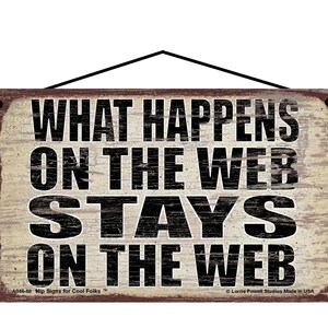 May include: A rustic wooden sign with a distressed white background and black text that reads "What Happens On The Web Stays On The Web". The sign has a brown border and a hanging rope.