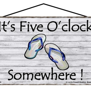 May include: White wooden sign with the text "It's Five O'clock Somewhere!" in black lettering. Two blue and white flip flops are pictured on the sign.
