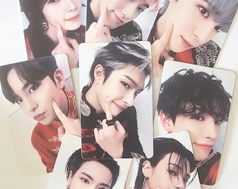 May include: Seven photo cards featuring different members of a K-pop boy band. Each card features a close-up portrait of a young man with a different hairstyle and expression. The cards are printed on white cardstock and have a glossy finish.