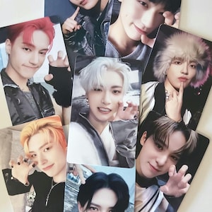 May include: A collection of glossy photo cards featuring various individuals with different hairstyles and expressions. The cards are rectangular and have a white background. The subjects are of Asian descent.