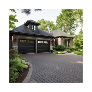 May include: A two-car garage with black garage doors and a brick exterior. The garage is attached to a house with a brown roof and a large window. The driveway is made of gray pavers.