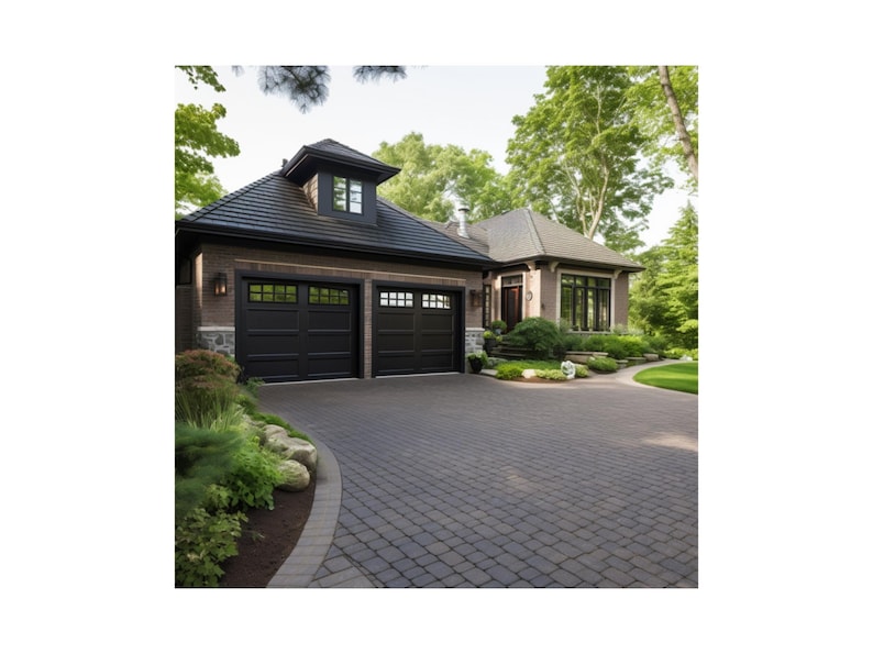 May include: A two-car garage with black garage doors and a brick exterior. The garage is attached to a house with a brown roof and a large window. The driveway is made of gray pavers.