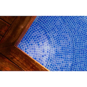May include: A close-up of a wooden deck corner with a blue tiled pool in the background. The pool tiles are arranged in a circular pattern.