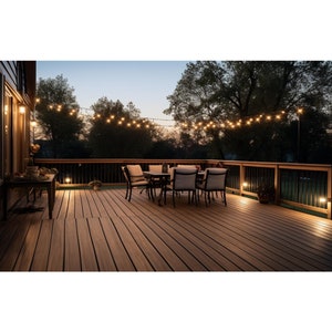 May include: A wooden deck with a dining set and string lights. The deck is made of brown composite decking boards. The dining set includes a table and four chairs. The chairs are made of black metal with white cushions. The string lights are strung across the deck and are lit. The deck is surrounded by a black metal railing.