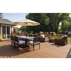 May include: A brown wooden deck with a patio set, including a table with six chairs, a white umbrella, and two wicker chairs with cushions. The deck is surrounded by green trees and a white house.