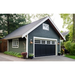 May include: A detached garage with a black garage door and white trim. The garage is painted a dark green color and has a small window above the door. The garage is surrounded by trees and bushes.