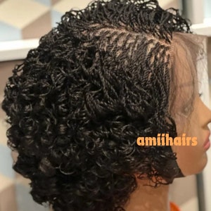 May include: A black wig with a curly style and a lace front. The wig is styled in small braids and has a natural looking hairline. The wig is labeled "amiilhairs".