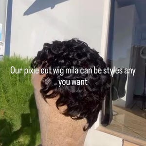 May include: A black pixie cut wig on a mannequin head. The wig has short, curly hair. Text on the image reads: "Our pixie cut wig mila can be styles any you want."