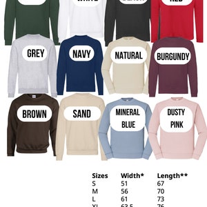 May include: A chart showing the size, width, and length of sweatshirts in various colors, including green, white, black, red, grey, navy, natural, burgundy, brown, sand, mineral blue, and dusty pink.