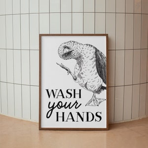 May include: Black and white illustration of a blue-footed booby bird with the text "WASH your HANDS" on a white background.