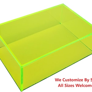 May include: A bright yellow, clear acrylic box with a rectangular shape. The box is empty and has a smooth, glossy finish. The text "We Customize By Size! All Sizes Welcome!!" is printed below the box.