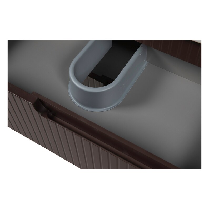 May include: A close-up of a brown wooden drawer with a gray plastic shoe holder inside. The drawer has vertical grooves and a rounded edge.
