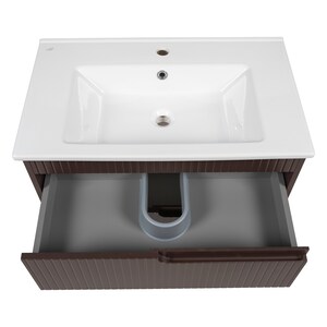 May include: A white ceramic bathroom sink with a single faucet and a brown wooden cabinet with a drawer. The drawer is open and reveals a gray interior with a white plastic pipe.