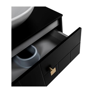 May include: Black bathroom vanity with a white ceramic sink and a gold drawer pull. The drawer is open and the interior is grey.