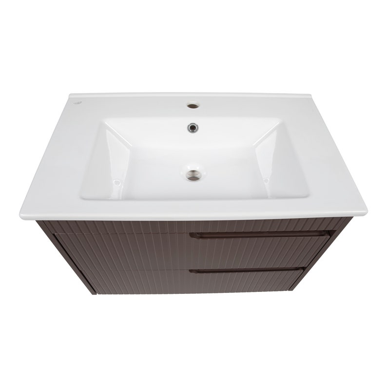May include: A white ceramic bathroom sink with a single faucet and a brown wooden cabinet with two drawers.