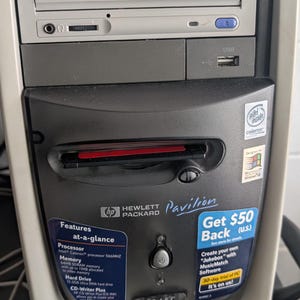 May include: A beige and dark gray Hewlett Packard Pavilion desktop computer tower featuring a CD-Writer Plus drive, a USB port, and an Intel Celeron processor. The front panel displays technical specifications, a power button, and promotional stickers.